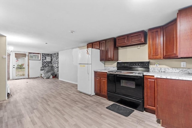 kitchen with white refrigerator, light wood-type flooring, and black / electric stove