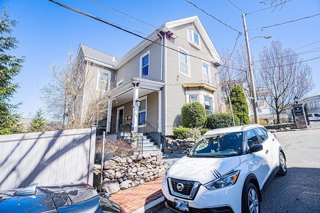 38 Highland Park Ave, Boston, MA 02119 - view of side of home with a porch and fence