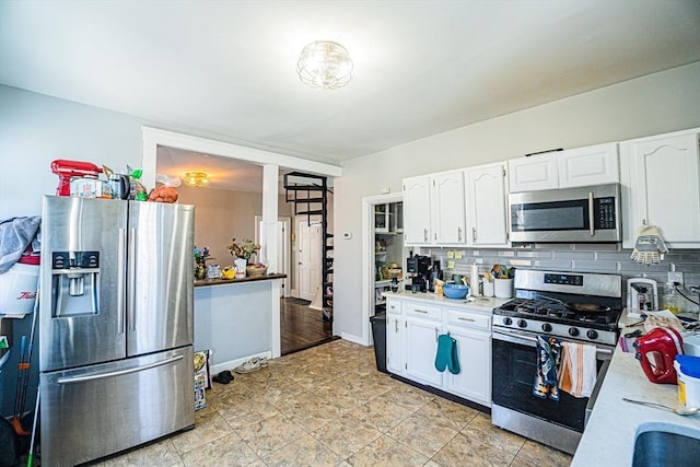 38 Highland Park Ave, Boston, MA 02119 - kitchen with light countertops, decorative backsplash, white cabinetry, and stainless steel appliances