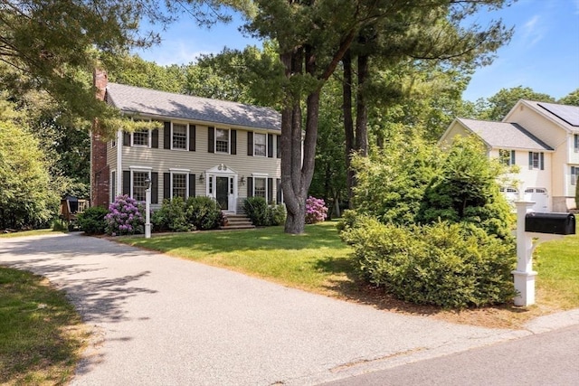4 Noel Rd, Andover, MA 01810 - colonial-style house featuring a chimney and a front lawn