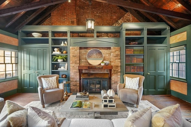 living room featuring wooden ceiling, a brick fireplace, vaulted ceiling with beams, wood-type flooring, and brick wall