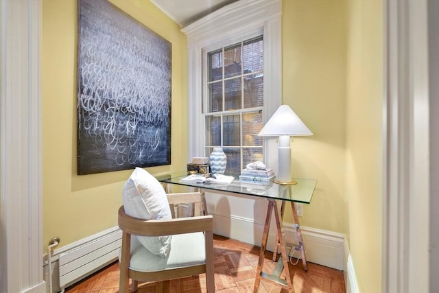 office space featuring parquet floors and a baseboard heating unit