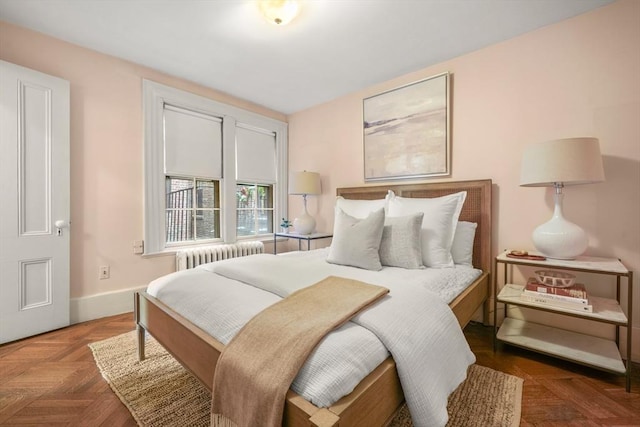 bedroom featuring dark parquet flooring and radiator heating unit