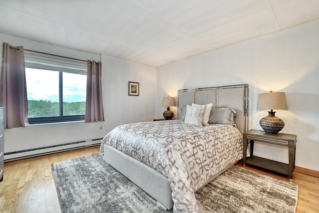 49 Melrose St Unit 7F, Melrose, MA 02176 - bedroom with a baseboard heating unit and wood finished floors