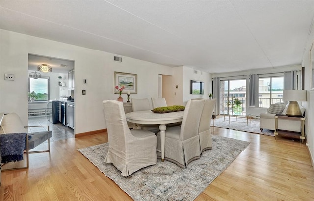 49 Melrose St Unit 7F, Melrose, MA 02176 - dining space with healthy amount of natural light and light wood finished floors