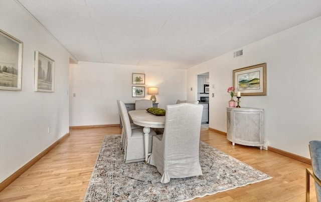 49 Melrose St Unit 7F, Melrose, MA 02176 - dining space featuring light wood-style floors and baseboards