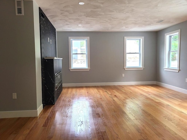54 Federal St, Weymouth, MA 02188 - unfurnished living room featuring a fireplace, light wood-type flooring, and baseboards