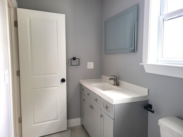 54 Federal St, Weymouth, MA 02188 - half bath featuring vanity, toilet, marble finish flooring, and baseboards