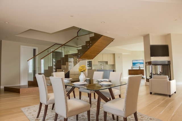 dining space featuring light hardwood / wood-style flooring and sink