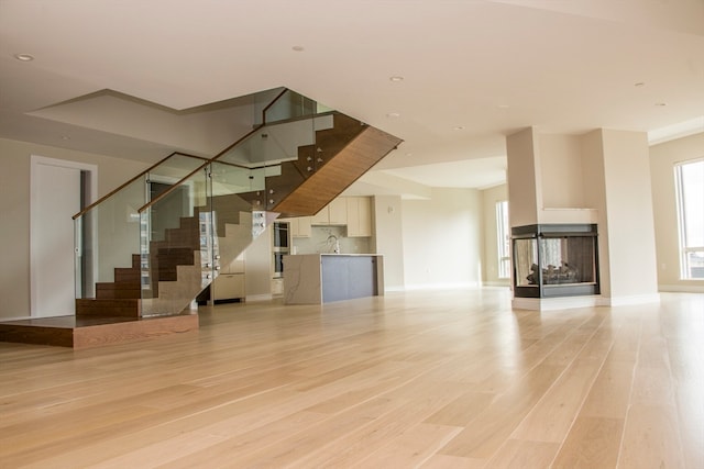 unfurnished living room featuring light wood-type flooring