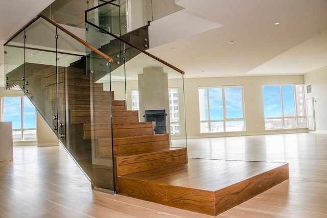 staircase with hardwood / wood-style flooring