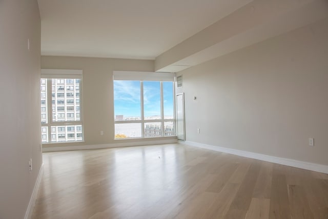 spare room featuring light hardwood / wood-style flooring