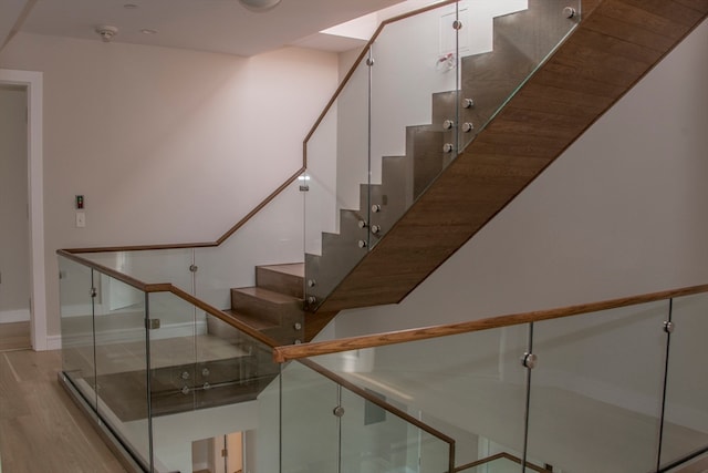 staircase with wood-type flooring