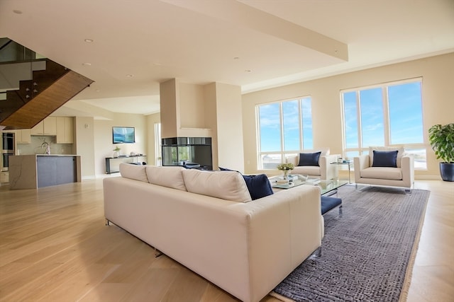 living room featuring sink and light hardwood / wood-style floors