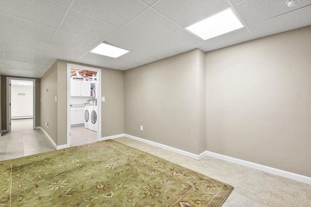 interior space with independent washer and dryer and a drop ceiling