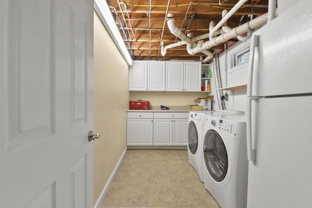 washroom featuring cabinets and independent washer and dryer