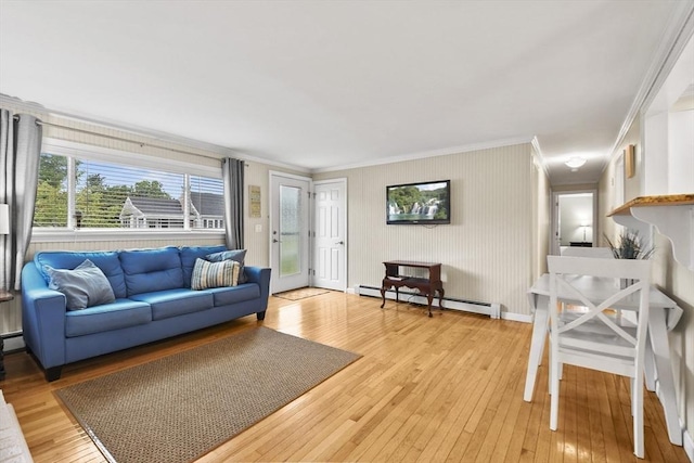 living room featuring hardwood / wood-style flooring, a baseboard radiator, and crown molding