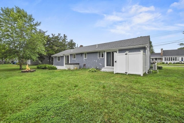 rear view of property with a yard