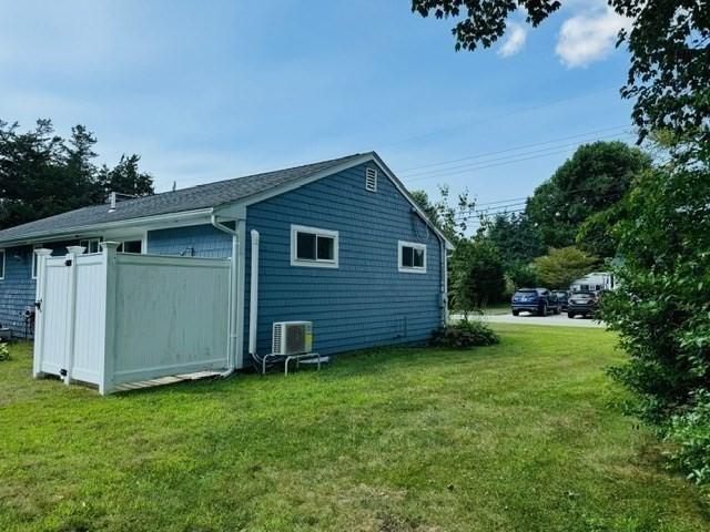 back of house featuring a yard and central air condition unit