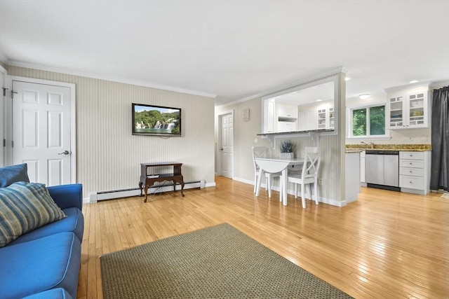 living room featuring a baseboard heating unit, light hardwood / wood-style floors, and ornamental molding