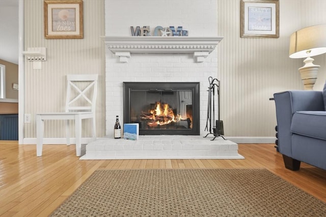 room details with a brick fireplace and wood-type flooring