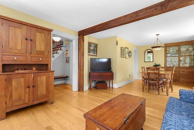 40 Maple St, Mansfield, MA 02048 - living area with stairs, light wood-style flooring, and beamed ceiling