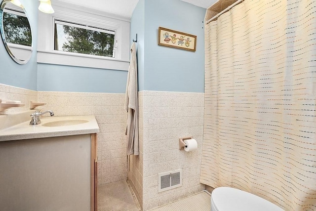 40 Maple St, Mansfield, MA 02048 - bathroom with tile walls, vanity, tile patterned flooring, curtained shower, and wainscoting