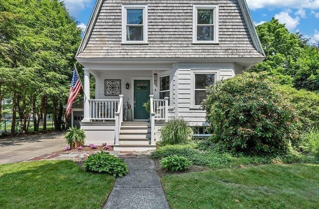 40 Maple St, Mansfield, MA 02048 - view of front of home with a porch and a front yard