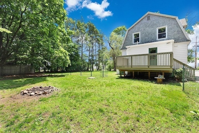 40 Maple St, Mansfield, MA 02048 - rear view of house with a deck, a gambrel roof, and an outdoor fire pit