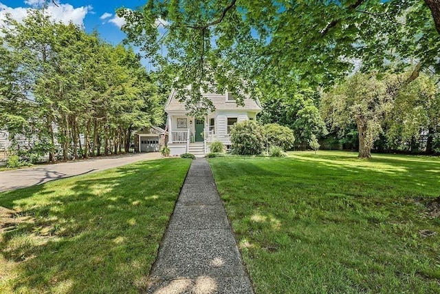 40 Maple St, Mansfield, MA 02048 - view of front of house featuring a front lawn, a detached garage, and an outdoor structure