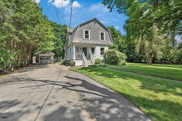 40 Maple St, Mansfield, MA 02048 - dutch colonial featuring an outdoor structure, concrete driveway, a gambrel roof, a front yard, and a porch
