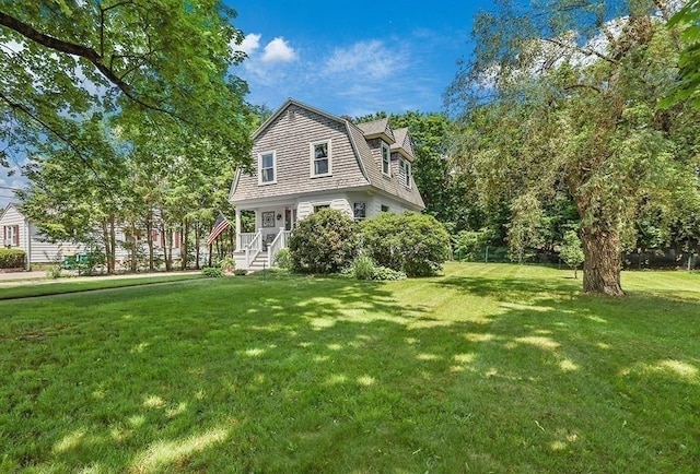40 Maple St, Mansfield, MA 02048 - view of front of home with a front yard and a gambrel roof
