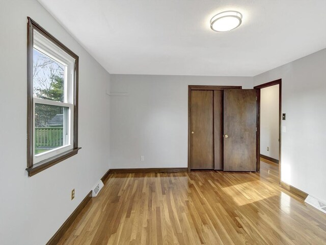 spare room featuring rail lighting and wood walls