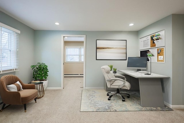 carpeted home office with baseboard heating and a wealth of natural light