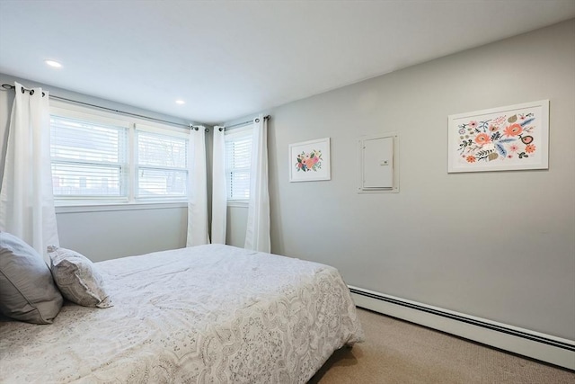 bedroom featuring carpet flooring and a baseboard heating unit