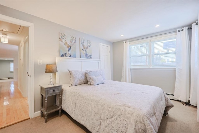 bedroom featuring light colored carpet and a baseboard radiator