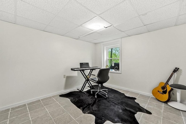 office with tile patterned flooring, a paneled ceiling, and baseboards