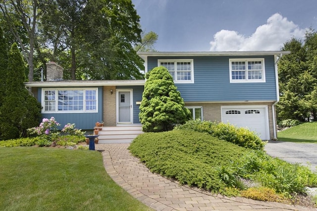 12 Crosby, Webster, MA 01570 - tri-level home with an attached garage, a chimney, asphalt driveway, a front yard, and brick siding