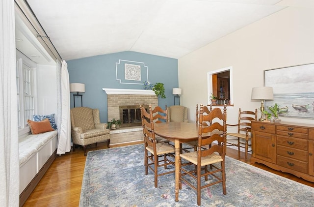12 Crosby, Webster, MA 01570 - dining space featuring wood finished floors, lofted ceiling, and a fireplace