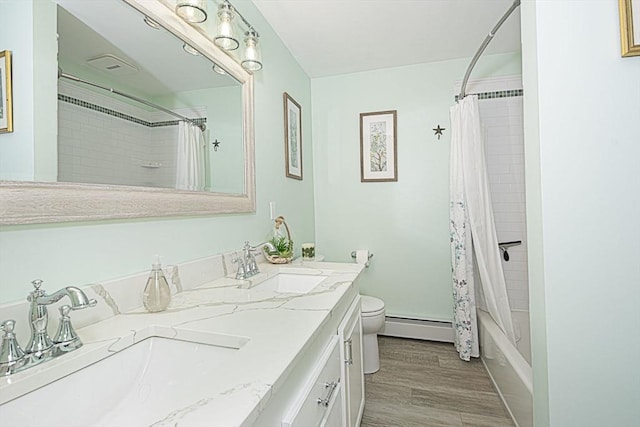 12 Crosby, Webster, MA 01570 - bathroom featuring a baseboard heating unit, double vanity, toilet, shower / bath combination with curtain, and wood finished floors