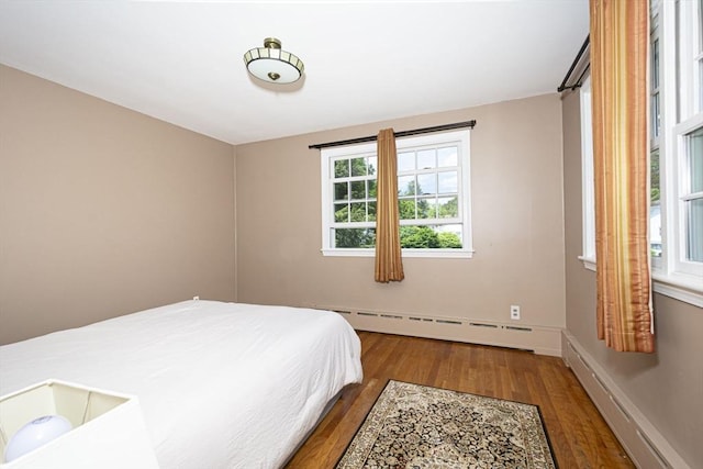 12 Crosby, Webster, MA 01570 - bedroom with baseboard heating, wood finished floors, a baseboard radiator, and baseboards