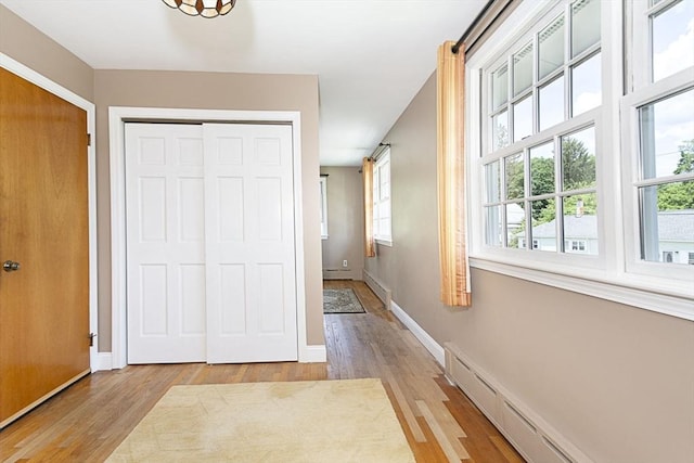 12 Crosby, Webster, MA 01570 - hall with a baseboard heating unit, light wood-type flooring, and baseboards