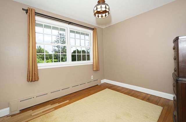 12 Crosby, Webster, MA 01570 - unfurnished room with baseboard heating, baseboards, and wood finished floors