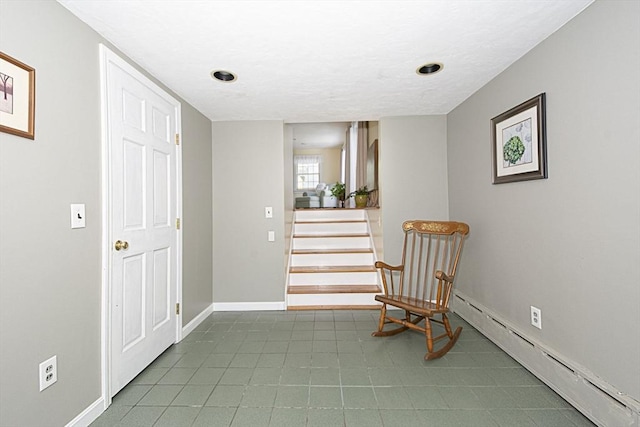 12 Crosby, Webster, MA 01570 - living area featuring a baseboard radiator, baseboards, and stairs