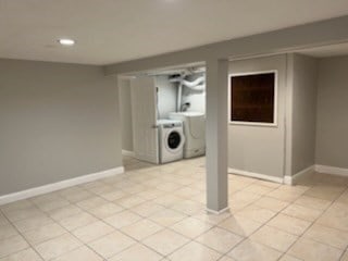 laundry room featuring light tile patterned floors and washer / dryer