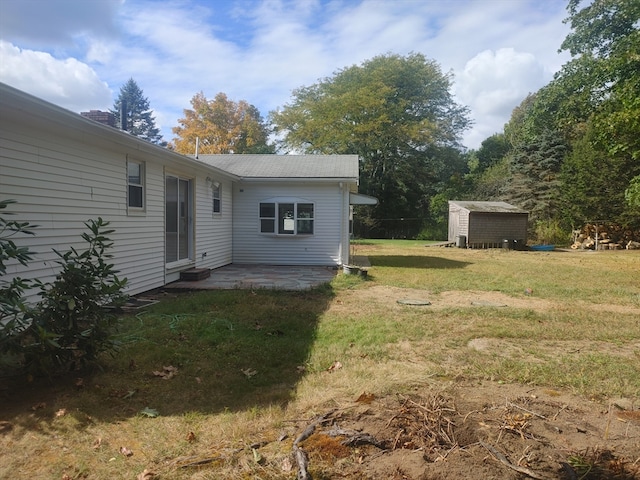 view of yard featuring a storage shed and a patio