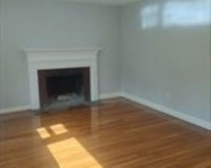 unfurnished living room featuring wood-type flooring