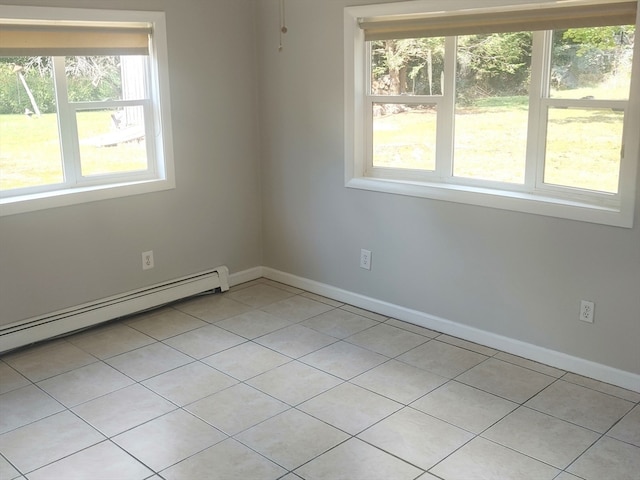 unfurnished room featuring baseboard heating, plenty of natural light, and light tile patterned floors