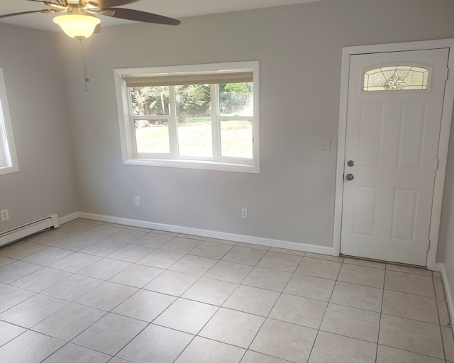 foyer entrance with ceiling fan, a baseboard radiator, and light tile patterned floors