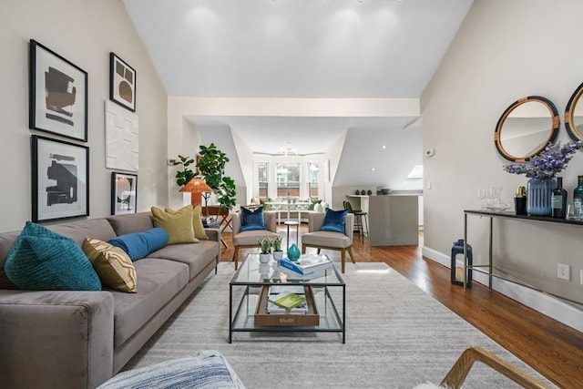 living room with hardwood / wood-style floors and lofted ceiling